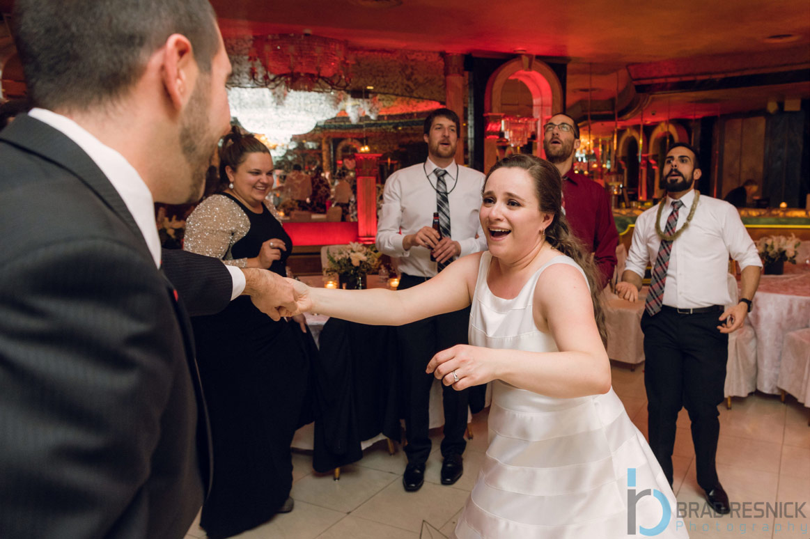 Bride rushing towards Wedding DJ on dancefloor