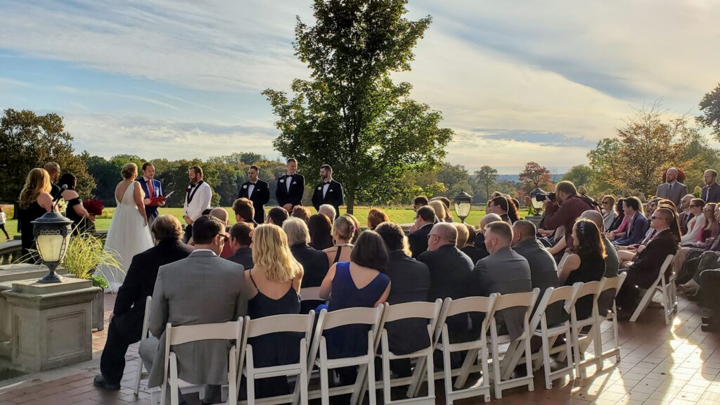Seated guests at outdoor ceremony at park for Waveny House Wedding