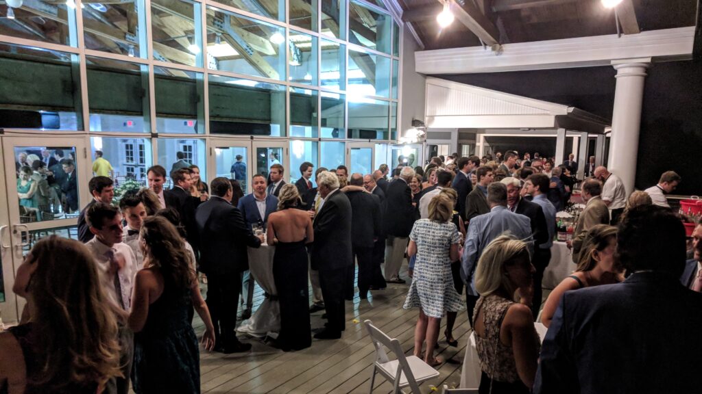 Cocktail hour for wedding at Penfield Pavilion on beachside boardwalk at night