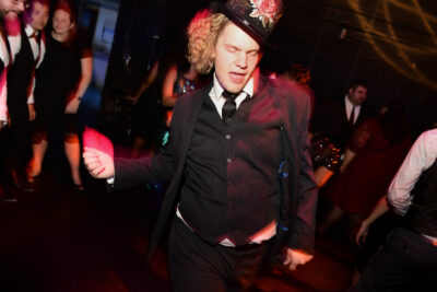 Stylish dancing on wedding dancefloor with flamboyant hat at The Colonial Theatre