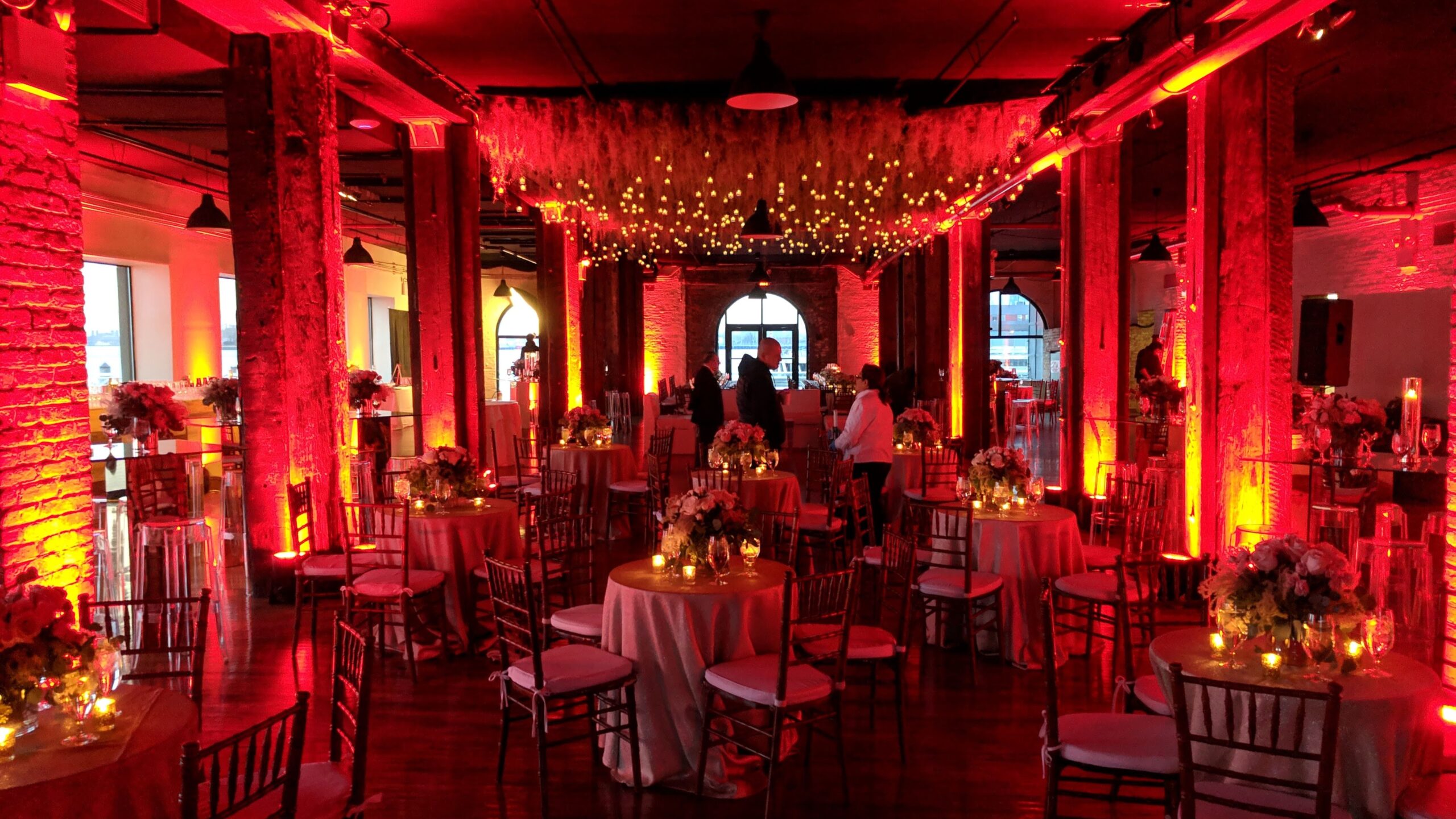Dinner seating with Red Uplighting at Rustic wedding venue Libery Warehouse Brooklyn NY