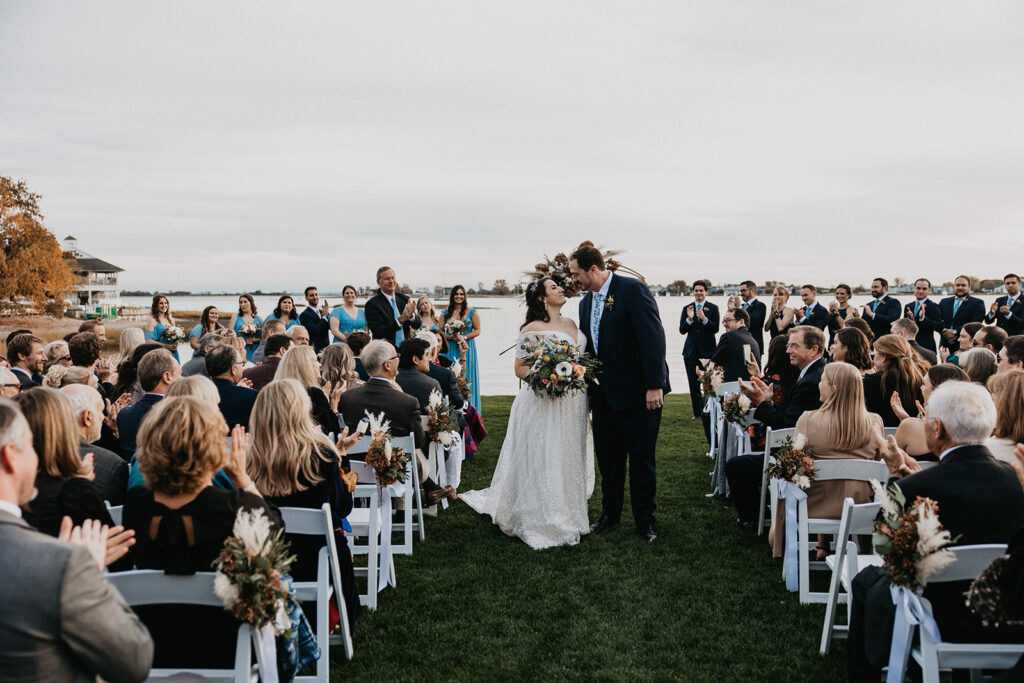 Couple walking down the aisle at the inn at longshore outdoor ceremony