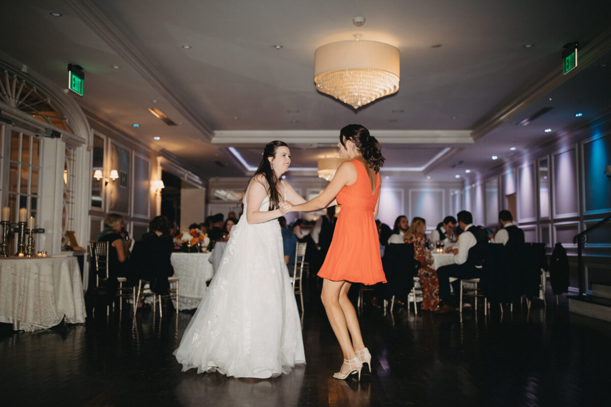 bride and bridesmaid on dancefloor at the briarcliff manor wedding
