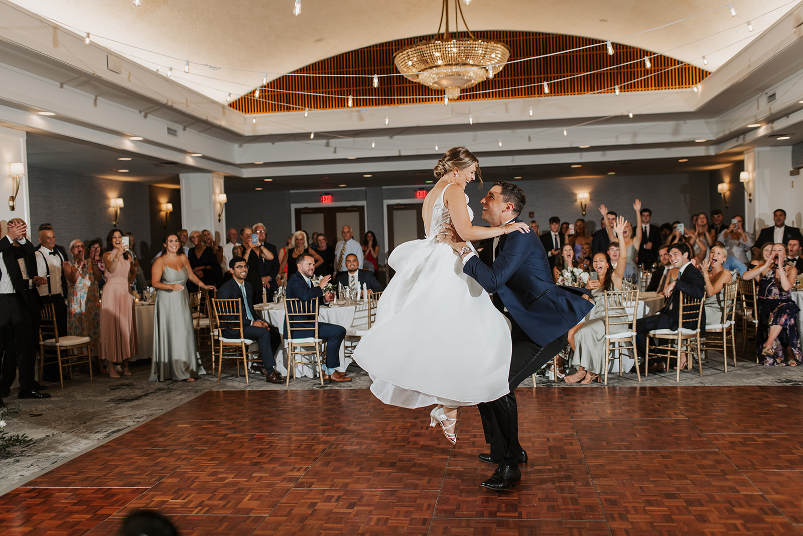 Waters Edge Wedding Venue, Westbrook CT groom lifting bride during first dance