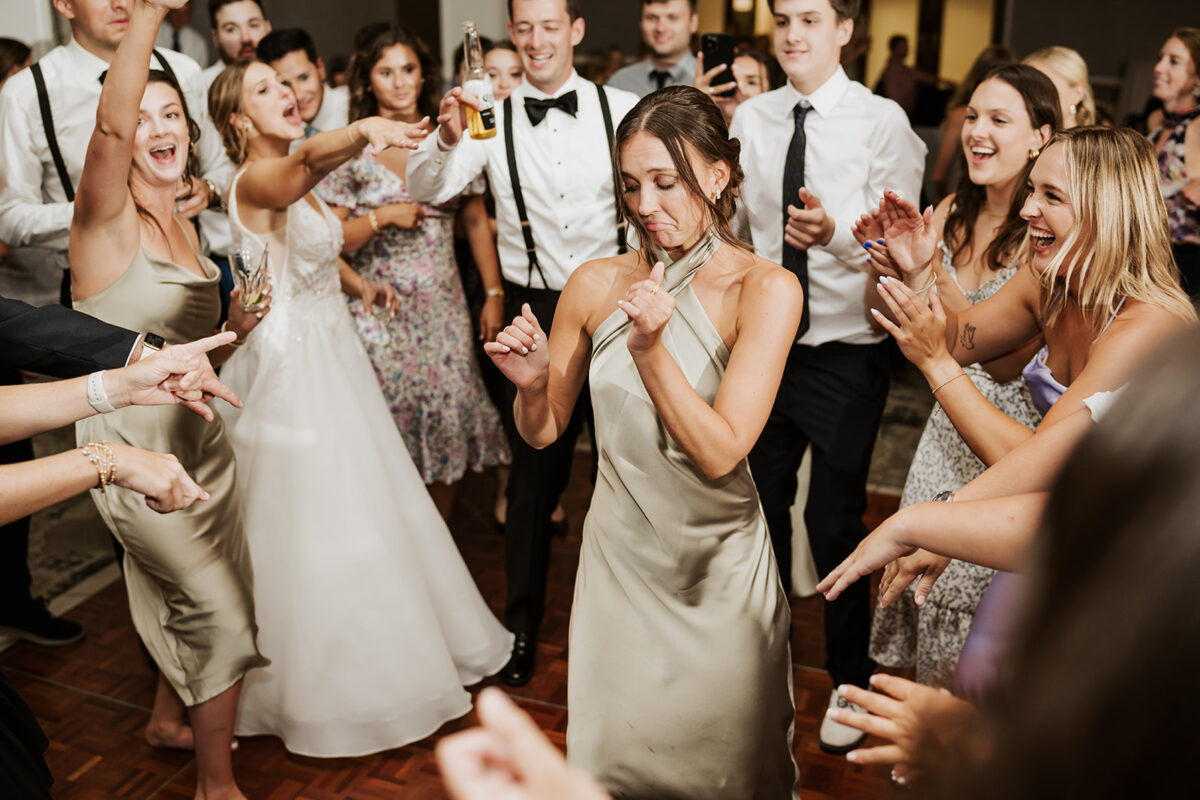 Waters Edge Wedding Venue, Westbrook CT wedding party dancing in a circle