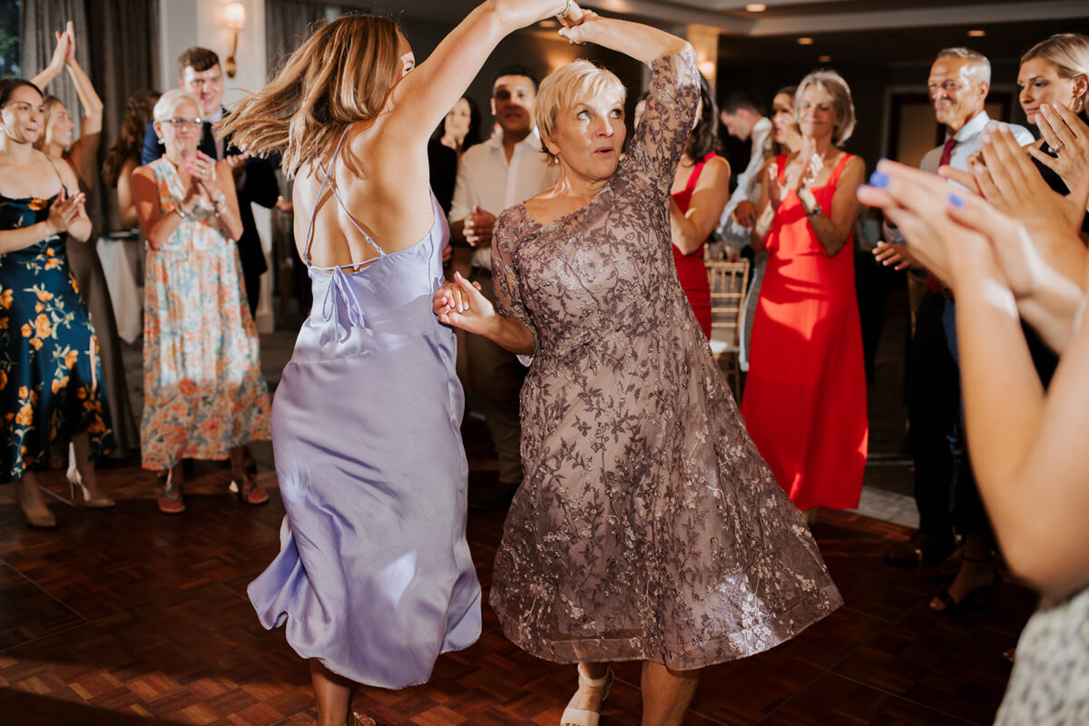 Waters Edge Wedding Venue, Westbrook CT guests twirling on dance floor