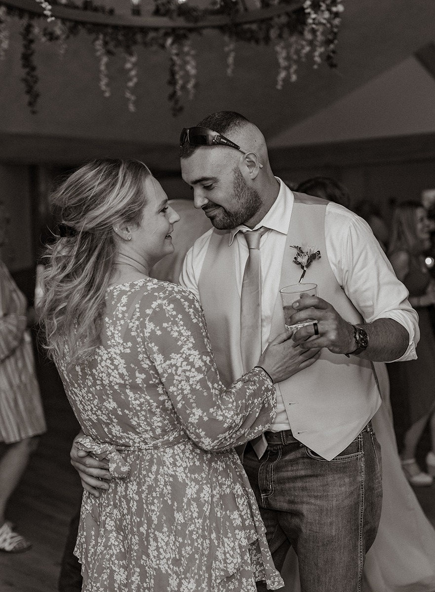 black and white photo of couple slow dancing at a wedding