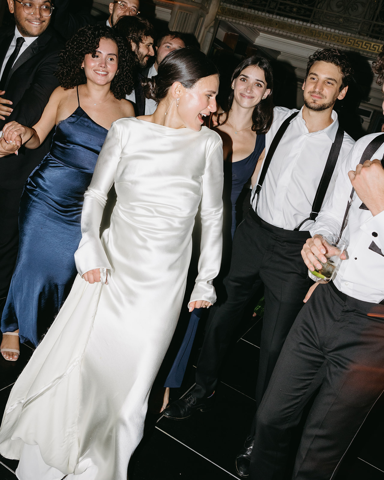 bride and crowd on dance floor at wedding
