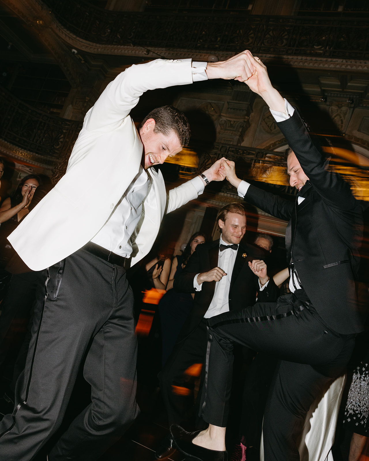 groom and groomsmen dancing at george peabody library wedding reception