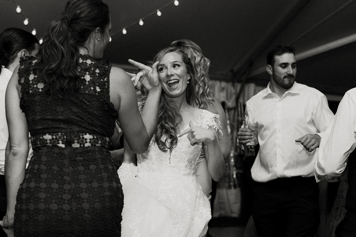 bride and guests on dance floor at a tented wedding reception in new hampshire