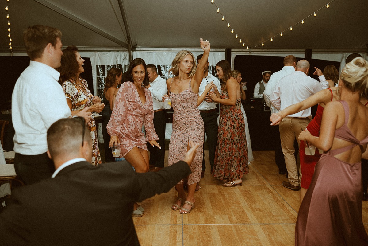 girls dancing on dance floor at backyard wedding