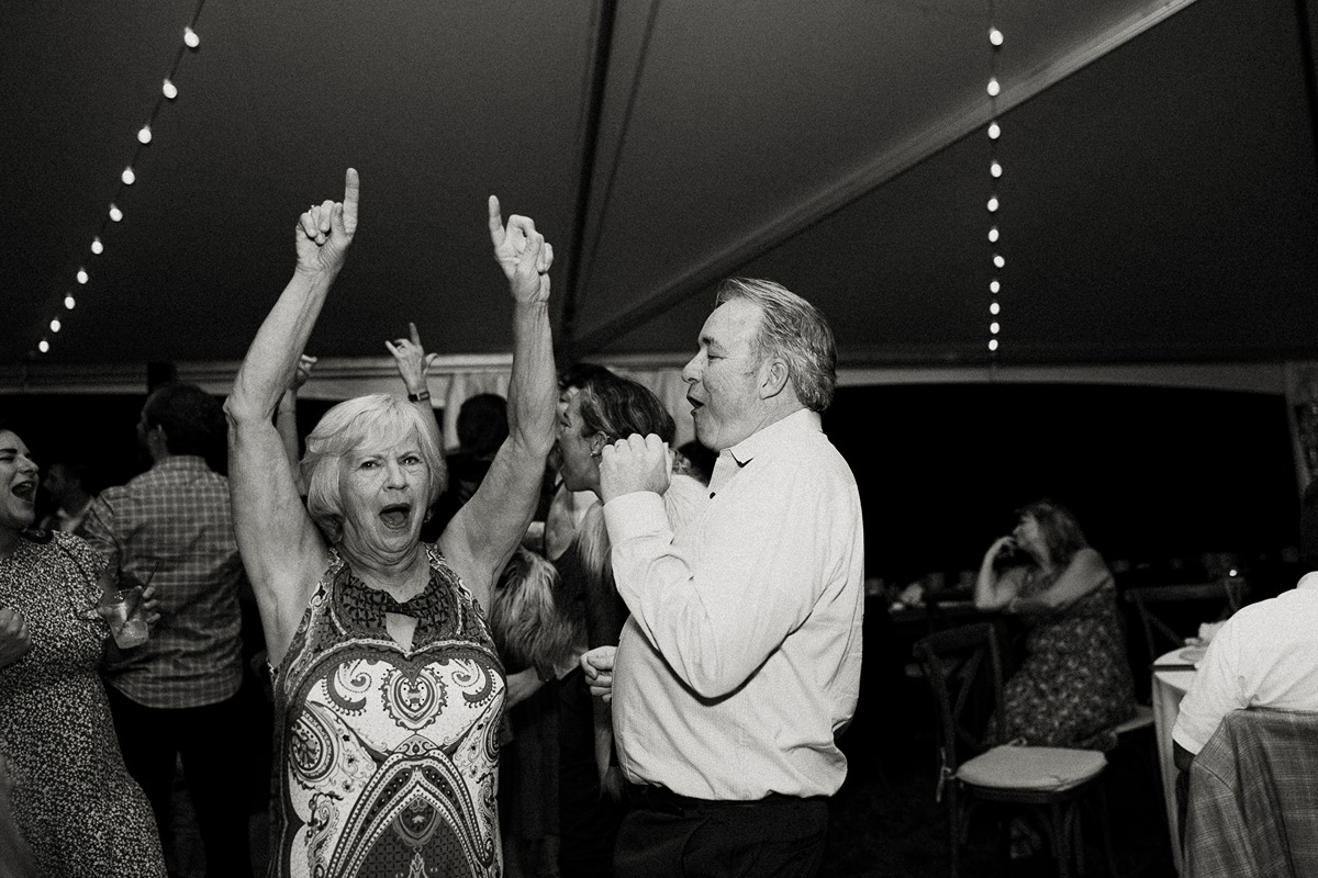woman singing along at tented wedding reception in new hampshire