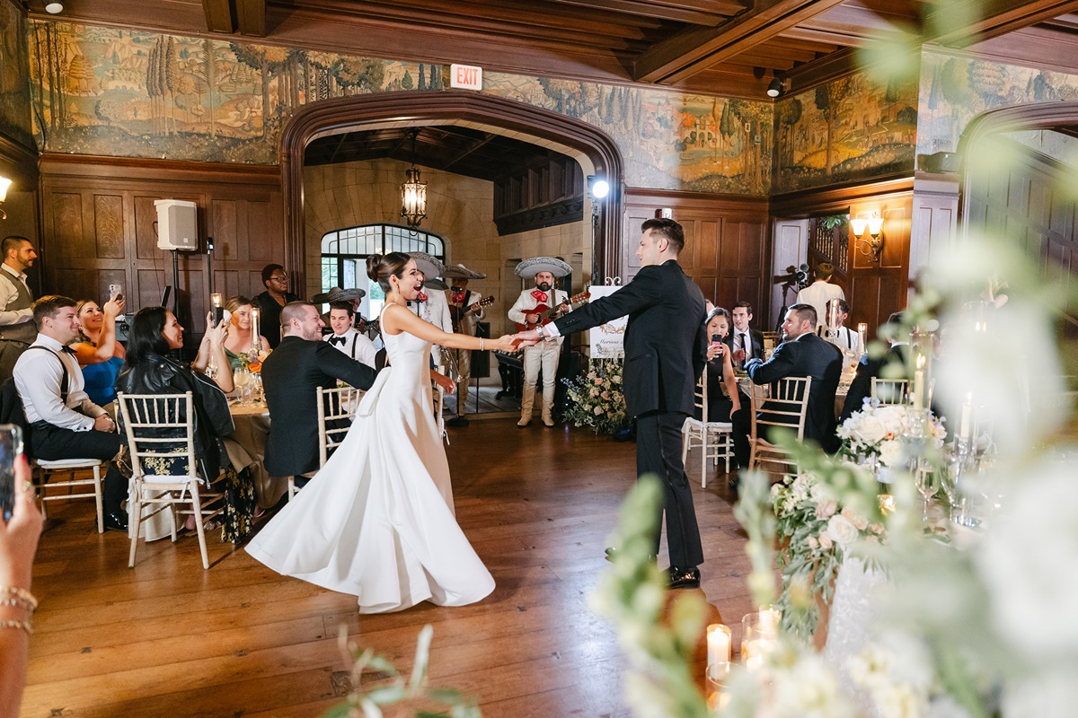 bride and groom dancing to mariachi band at wedding reception