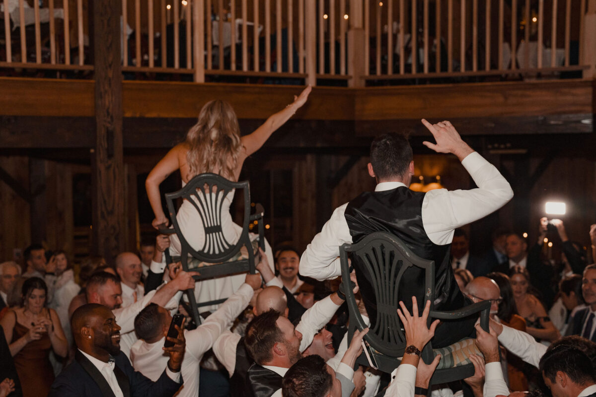 Bride and groom hoisted into the air at their wedding for the hora at The Preserve at Chocorua in Tamworth NH