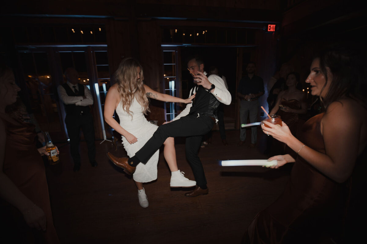 Bride and groom dancing at their wedding with drinks in hand at The Preserve at Chocorua in Tamworth NH