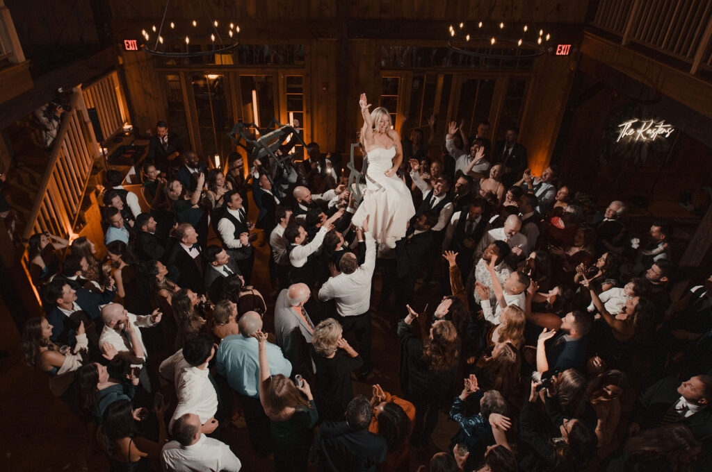 Bride on dancefloor up in air for the hora at The Preserve at Chocorua in Tamworth NH