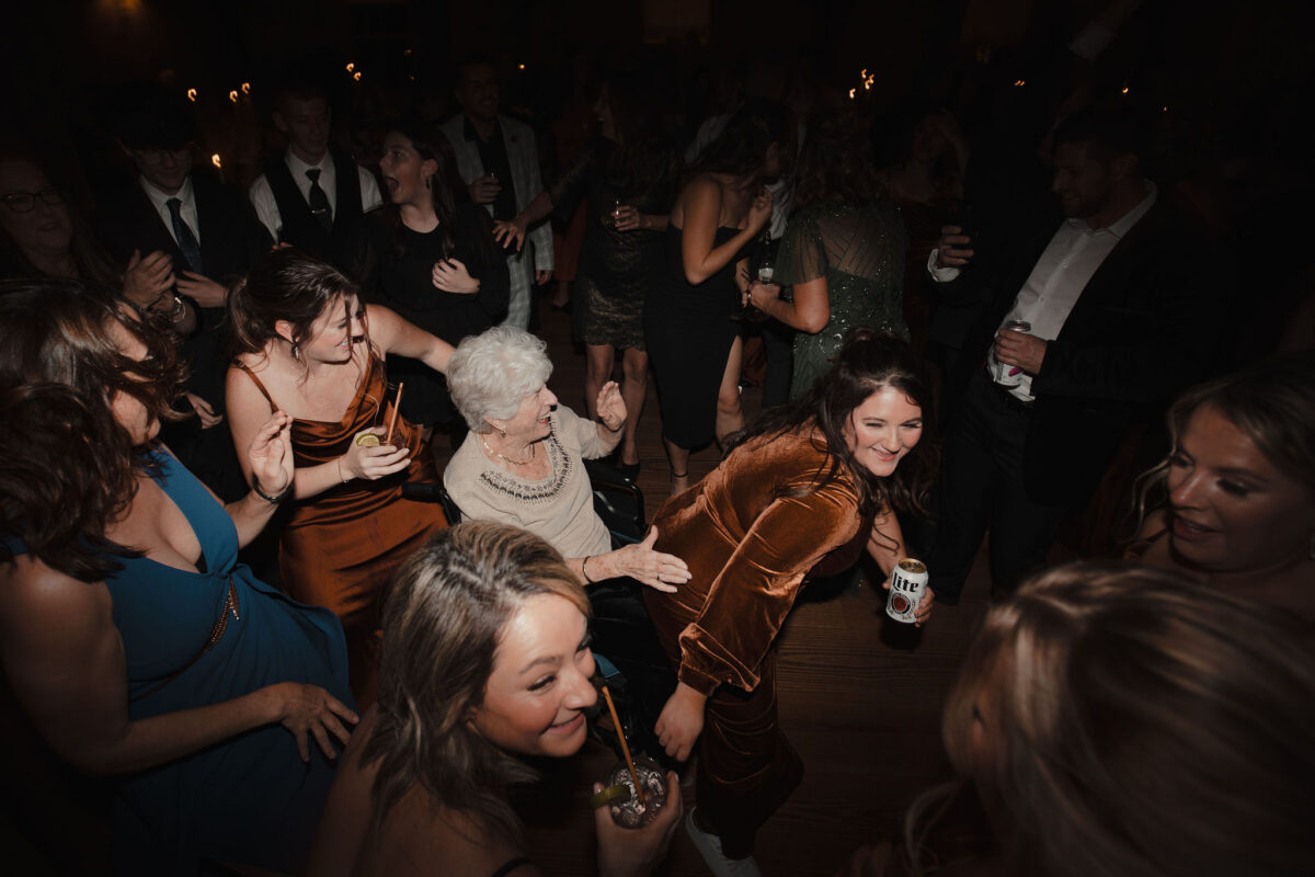 Fun guests smiling and dancing with grandma at wedding The Preserve at Chocorua in Tamworth NH