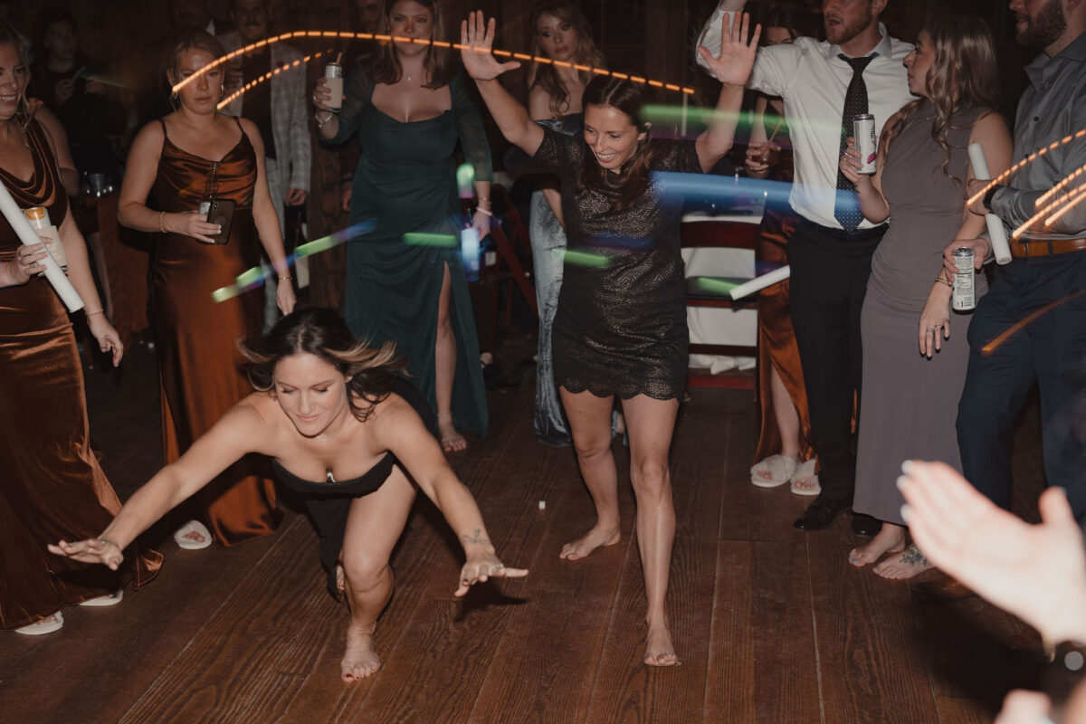 Ladies break dancing and jumping down to do the worm at wedding at The Preserve at Chocorua in Tamworth NH