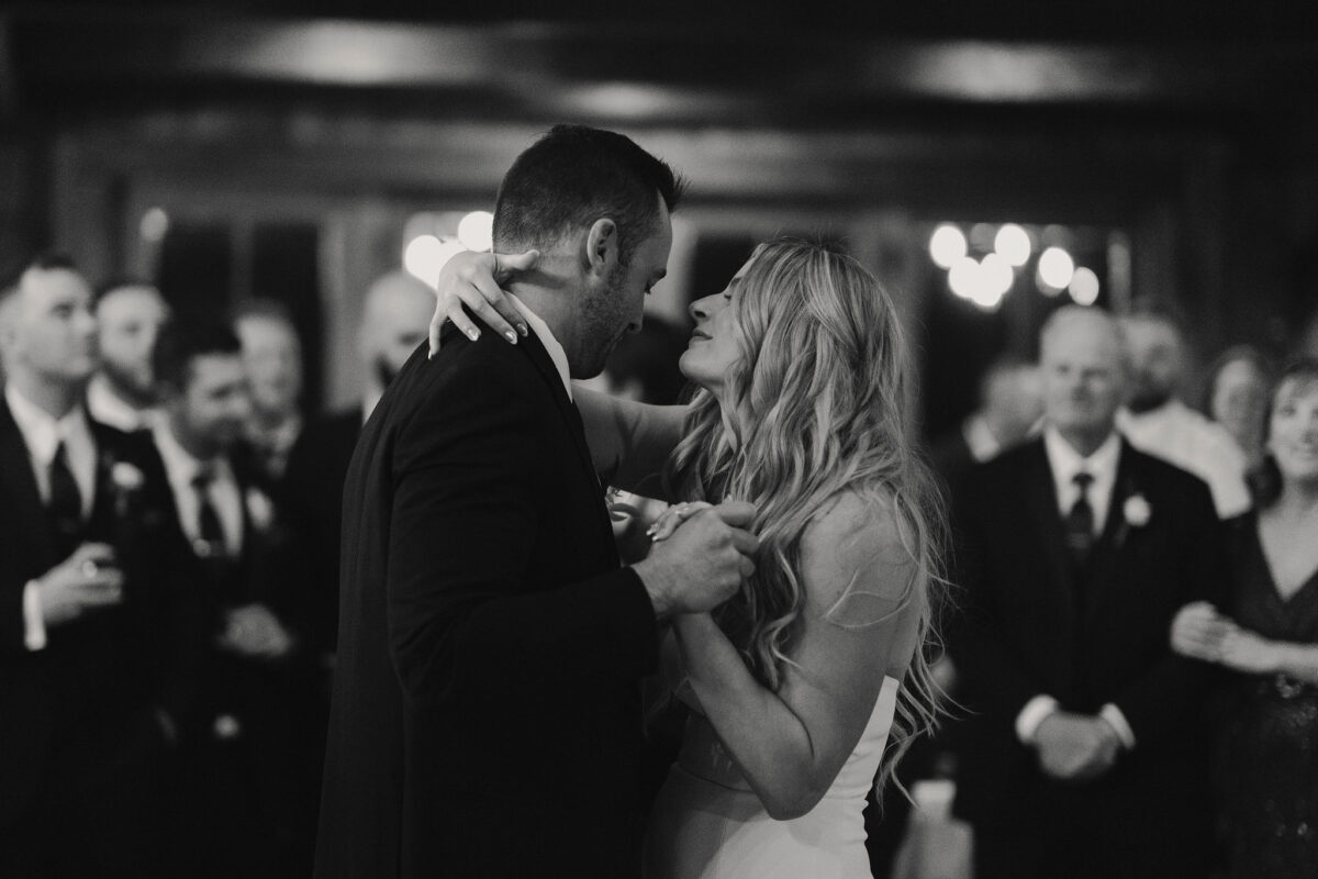 Bride and groom embracing during first dance for their wedding at Father of bride holding microphone during lip sync performance at daughters wedding at The Preserve at Chocorua in Tamworth NH